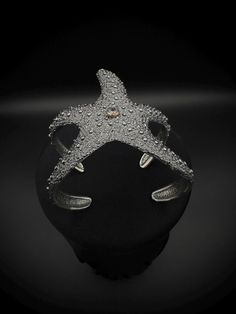 These Star Fish designed  jewelry is made of from 925k sterling silver which has a hypoallergenic quality, so people with metal allergies can wear it without experiencing any skin irritation. Also fully adjustable for all kind of wrist. During the completion of the jewelry, we create antique look and texture by oxidizing the silver. For the eyes of the octopus, I use zircon stones and bronze around them to look like realistic effect. It is handcrafted in 925k Sterling Silver. So it's Water, sweat, heat resistant (No Discoloring or Tarnishing). Luxury Starfish-shaped Jewelry Gift, Adjustable Silver Star Bracelet, Adjustable Silver Star Bracelets, Silver Star-shaped Formal Jewelry, Silver Star-shaped Jewelry For Formal Occasions, Silver Star-shaped Jewelry For Formal Events, Elegant Starfish Bracelet For Gift, Elegant Silver Starfish Jewelry, Handmade Silver Star Bracelets