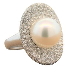 This characterful ring features a 12mm South Sea pearl in the center of a concave oval shape of this 18K white gold ring. The setting with 2.60 carats of shimmering round cut diamonds is reminiscent of a pearls shell. This cocktail ring is delicate as it is fun. Ring Size 6.75 (Sizable) Pearl Ring Designs, Pearl Ring Design, Diamond Gold Ring, Diamond Bracelet Design, Golden South Sea Pearls, Fancy Yellow Diamond, Pearl And Diamond Ring, Gold Cocktail Ring, Black Diamond Ring