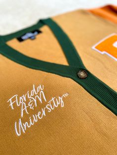 an orange and green jersey with the words florida a & m university written on it