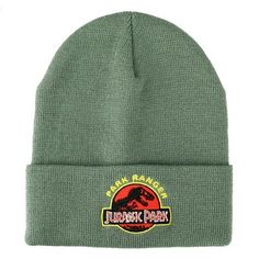 a green beanie hat with the words park ranger and an image of a dinosaur on it