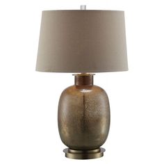 a table lamp with a beige shade on it