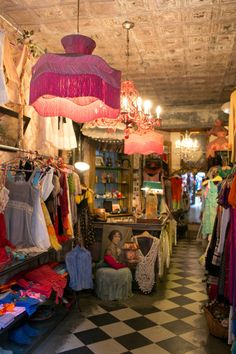 a clothing store with chandeliers hanging from the ceiling and other items on display