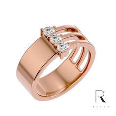 a rose gold ring with two diamonds on it's sides and the words r written in