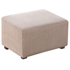 a beige ottoman sitting on top of a white floor