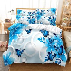 a bed with blue flowers and butterflies on it