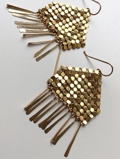 Modern fringed earrings feature panels of gold metal mesh reclaimed from a vintage, mid-century purse (circa 1960-1980s) atop glittering stands of hand hammered, 14k gold filled drops. Ruoko Mesh Earrings measure 2.25" tall x 1.5" wide. 14 karat gold filled frames and earrings. Each earring signed with our logo link. Gold Fringe Metal Chandelier Earrings, Gold Fringe Earrings In Brass, Gold Fringe Chandelier Earrings, Gold Metal Chandelier Earrings For Evening, Gold Fringe Chandelier Earrings As Gift, Gold Beaded Long Drop Earrings, Handmade Gold Earrings For Evening, Glamorous Gold Fringe Earrings, Handmade Gold Chandelier Earrings For Party