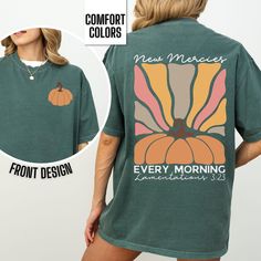 You will love our Comfort Colors fall Christian t-shirt for women. It is based on the Bible verse Lamentations 3:23. It has a beautiful pumpkin and sunrise graphic on the back and a pumpkin on the pocket area of the front of the shirt. This Comfort Colors tee comes in 5 beautiful fall colors, pepper, blue spruce, ivory, blossom, and denim. This is the perfect autumn top for any women to wear to fall festivals at church, the pumpkin patch or to a Thanksgiving gathering.   Comfort Colors T shirt D Green Graphic Tee For Fall, Orange Short Sleeve T-shirt For Fall, Bible Verse T Shirt, Sunrise Graphic, Fall Christian, Christian Thanksgiving, Thanksgiving Gathering, Pumpkin Tshirt, Fall Festivals