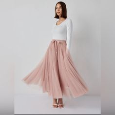 Women's Aria Tulle Midi Skirt In Old Rose. Long Tulle Skirt, With A Thin Elastic Band At The Waist. Over 11m Of Tulle. Playing With Layers And Volume, This Iconic Skirt Is Distinguished By A Flared Cut, Enhanced With Ruffles, Offering A Ruffle Effect On The Bottom. The Skirt's Lightweight Design Features A Signature Ethereal Feel And Fluid Movement, For Effortless Feminine Style. Perfect For Day Or Evening, Dress It Up With Heels, Or Wear It Casual With A Pair Of Sneakers. Material: 100% Polyest Blush Tulle Skirt, Autumn 23, Pink Tutu Skirt, Pink Tulle Skirt, Fluid Movement, Tulle Long Skirt, Tulle Midi Skirt, Pink Tutu, Old Rose