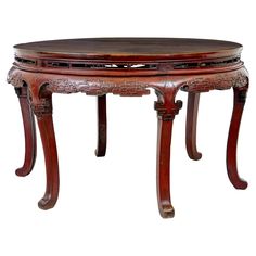 an old wooden table with carvings on the top and bottom, sitting against a white background