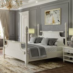 a white bed sitting in a bedroom on top of a wooden floor next to a chandelier