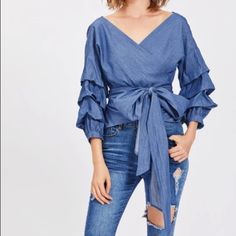 Gathered-Sleeve Denim Wrap Top With Off The Shoulder Fit. 100% Cotton Chic V-neck Denim Top For Spring, Chic Spring Denim V-neck Top, Spring V-neck Denim Top, Chic Blue V-neck Denim Top, Blue Denim Top For Fall Day Out, Chic Denim Blue V-neck Top, V-neck Denim Blue Top For Spring, Spring Denim Blue V-neck Top, Chic Long Sleeve Denim Blue Top