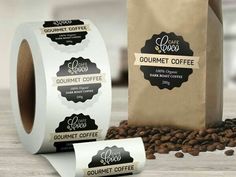 two rolls of coffee next to a bag of coffee beans on a wooden table with the label for gourmet coffee