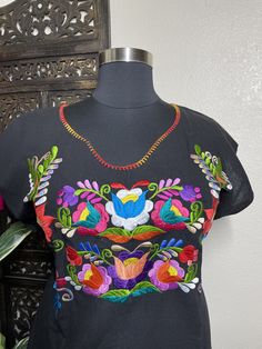 "Beautiful hand embroidered dress! This has been made and brought directly from Chiapas, Mexico. The embroidery is 100% handcrafted. All the work on this dress has a professional skilled finish and the multicolor embroidered makes it look even more eye catching. The embroidery work is made with great quality thread. The eye catching will be on the embroidered work, which is exquisite looking. Beautiful and clean work! Very light weight and fresh looking. SINCE THESE ARE EACH HANDMADE, EMBROIDERY Traditional Multicolor Embroidered Top For Fiesta, Multicolor Cotton Embroidered Dress With Border, Folk Style Embroidered Dress With Multicolor Hem, Multicolor Folk Dress With Embroidered Border, Fiesta Embroidered Cotton Dress With Multicolor Embroidery, Traditional Short Sleeve Dress With Multicolor Embroidery, Traditional Multicolor Embroidered Neckline Dress, Multicolor Floral Embroidered Short Sleeve Dress, Traditional Multicolor Dress With Embroidered Neckline