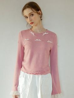 This is a t-shirt with a ribbon attached to the top of the garment. Rather than simple printing, ribbons are added to the clothes, creating a more three-dimensional and feminine mood. White see-through fabric was added to the ends of the sleeves. - Neat silhouette with round neck- Design that looks like fabric has been added to the hem- The design of the sleeves gets wider toward the end, giving the effect of making the arms look thinner. Chic Spring Tops With Ribbon, Feminine Tops With Ribbon For Spring, Feminine Ribbon Tops For Spring, Pink Tops With Ribbon For Spring, Pink Ribbon Tops For Spring, Bell Sleeves Top, Sleeves Top, The Clothes, Neck Designs