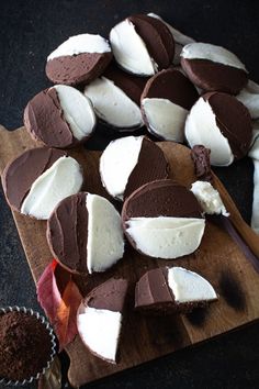 several pieces of chocolate and marshmallows on a cutting board