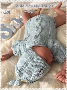 a baby wearing a knitted blue outfit laying on top of a white blanket with the words jali written below it