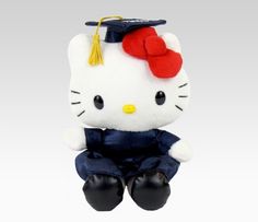 a hello kitty stuffed animal wearing a graduation cap