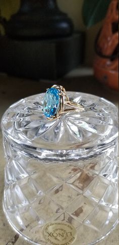 "D E S C R I P T I O N: 14kt Gold Blue Topaz Contemporary Ring; Large Oval Stone This wonderful piece of estate jewelry consists of a authentic large oval blue topaz stone set into a contemporary 14kt gold setting. It's in nice condition with very little signs of use. The large oval topaz is clear and faceted perfectly pick up the light and give a brilliant sparkle. This ring makes a statement and will definitely not disappoint. Beautiful!! Comes wrapped in the small Lenox crystal bowl pictured. Modern Oval Topaz Ring For Formal Occasions, Oval Topaz Ring For Formal Occasions, Modern Oval Topaz Ring With Polished Finish, Modern Oval Blue Topaz Ring, Formal Oval Topaz Ring With Polished Finish, Blue Oval Topaz Ring In 14k Gold, Oval Blue Topaz Ring In 14k Gold, Modern Oval Blue Topaz Jewelry, Formal Oval Topaz Ring