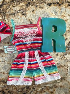 I love Serape and I love the ease of rompers! And I hope you do too! This Serape Romper is the most adorable color combo of pinks, red, blues and greens! Up to 2t has legs snaps, 3t and above do not. FIT: ⏩ If your child has a long torso you may want to size up 1 size. Please refer to size chart. High quality lace, bright Serape stripes and the ease of leg snaps.... I mean come on Summer! 😎 Because each romper is unique and one of a kind, pattern placement will vary 95% Cotton 5% Spandex Machin Cute Pink Jumpsuits And Rompers For Vacation, Playful Red Jumpsuits And Rompers For Summer, Playful Red Summer Jumpsuit, Cute Pink Beach Jumpsuits And Rompers, Cute Pink Jumpsuits And Rompers For Beach, Pink Cute Jumpsuits And Rompers For The Beach, Pink Beach Jumpsuits And Rompers, Multicolor Jumpsuits And Rompers For Spring Playtime, Cute Multicolor Jumpsuits And Rompers For Playtime