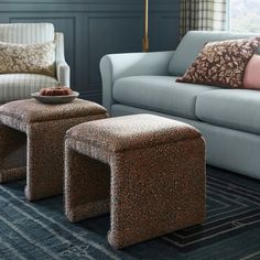 a living room filled with furniture and pillows on top of a blue carpeted floor