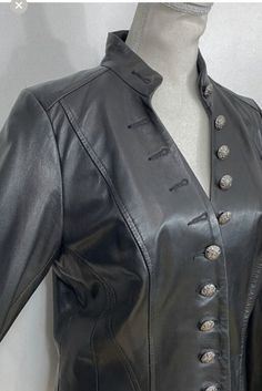 Beautiful jacket in good condition.  You may wish to have buttons more tightly secured.  Buttersoft leather with slightly wide long sleeves.  Taped seaming details, stand up collar, 4 closed buttonholes on top and 2 closed on bottom.  You could have these opened by a leather expert.  Waistline is tailored.  Jacket is lined but not overly heavy with no shoulder pads.  Flared at hem.  Measurements are as follows and are approximate: Sleeve  length 25 inches Sleeve width 5.75 inches Shoulder to shoulder 15 inches Chest 16 1/2 inches Armpit to armpit 21 inches Length 24 inches If you need to return due to fit you, the buyer are responsible for return shipping and item must be received back in the same condition in which it was shipped out. Thank you. Double-breasted Leather Jacket With Buttons, Formal Button-up Leather Jacket With Buttons, Black Double-breasted Leather Jacket With Buttons, Formal Button-up Leather Jacket, Fitted Double-breasted Leather Jacket With Buttons, Vintage Black Leather Jacket With Button Closure, Black Vintage Leather Jacket With Button Closure, Vintage Leather Jacket With Buttons For Business, Womens Black Leather Jacket