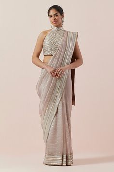 Taupe saree in silk organza base with silver and gold aari, sequin and zari work. Paired with a halter neck blouse and petticoat. - Aza Fashions Sleeveless Chanderi Pre-draped Saree For Festive Occasions, Festive Chanderi Pre-draped Saree With Sequins, Diwali Sequined Chanderi Pre-draped Saree, Festive Pre-draped Chanderi Saree With Sequins, Sequin Chanderi Pre-draped Saree For Reception, Silk Anarkali Pre-draped Saree With Sequins, Silver Pre-draped Saree With Mirror Work For Diwali, Traditional Chanderi Pre-draped Saree With Sequins, Festive Chanderi Saree With Sequins