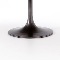 a round table with a black base on a white background