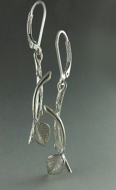 Hand sculpted Sterling Silver Leaf & Twig Earrings with tiny Buds and a Leaf perfectly balanced. Materials: Sterling Silver (shown) When I started developing my style 7 years ago, I was into nature. I was living in South Florida and couldn't stop looking at the Banyan Tree, they were beautiful. Beautiful glossy leaves that clustered together and those amazing roots...Once the roots get to the ground, they soak up nutrients and grow faster and thicker. They cover the trunk of the host tree, a Nature-inspired Drop Earrings With Lever Back Ear Wires, Nature-inspired Sterling Silver Pierced Earrings, Twig Earrings, Branch Earrings, Banyan Tree, Beautiful Beautiful, Dangling Earrings, Tree Branch, Earrings Sterling Silver