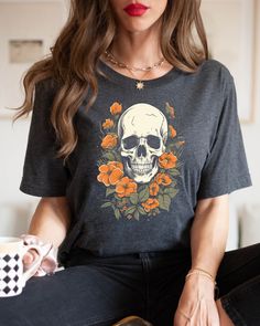 "We think this Whimsigoth style shirt is awesome! check out the skull and floral design, perfect for Halloween, drinking a coffee by the fireplace. We believe in comfort and quality. Our unisex T-shirts are super soft, ultra-comfy, and made with premium materials that feel as good as they look. ABOUT THE SHIRT 💙Our T-shirts are sourced from BELLA+CANVAS! FABRIC 👕Solid Colors: 100% Ringspun Cotton 👕Heather Colors: Soft cotton-poly blend (52% cotton, 48% polyester) SIZE AND FIT ✌🏼This style is Gothic Skull Print T-shirt For Fall, Casual Tops With Skull Shape For Alternative Fashion, Gothic Short Sleeve T-shirt With Skull Print, Gothic Cotton Top With Skull Print, Relaxed Fit Skull Print Top For Halloween, Gothic Skull Print Tops For Fall, Halloween Skull Cotton Shirt, Skull Print Graphic Tee For Alternative Fashion, Graphic Tee With Skull Print For Alternative Fashion