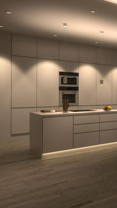 a modern kitchen with white cabinets and wood flooring is illuminated by recessed lighting