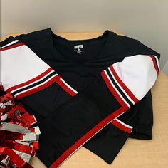 a hockey jersey laying on top of a wooden table next to ribbons and bows,