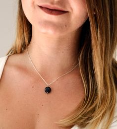 Shungite is estimated to be over 2 billion years old and found in the Karelia Region of Russia. It is said to help detoxify and purify the body by absorbing and eliminating any negative energies and clearing dysfunctional patterns. It is also believed to be a psychic protection stone and useful in protection from EMFs.This necklace is handcrafted with a natural Shungite stone in a smooth polished coin shape. It can be made in sterling silver or 14k gold filled.MATERIALS- Natural, Genuine Shungit Spiritual Black Necklace With Raw Stone, Obsidian Natural Stones Necklace For Gift, Gift Obsidian Necklaces With Natural Stones, Gift Obsidian Necklace With Natural Stones, Black Round Pendant Jewelry With Natural Stones, Black Necklaces With Round Pendant And Natural Stones, Gift Black Natural Stone Necklaces, Minimalist Black Necklace With Natural Stones, Black Obsidian Necklace For Gift