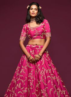 Hot Pink Zari Embroidered Silk Lehenga Choli will make you look more beautiful on this wedding season with indian ethnic essence. This set comprises of traditional zari, resham dori, stone and beads work on art silk lehenga with can can detailed satin lining paired with all over equally embellished art silk blouse. The beauty part is it’s zari border and butti embroidered soft net dupatta. Style this set with heels and golden jewellery to look stunning with all bridal drama. This set comprises o Festive Choli With Intricate Embroidery In Dola Silk, Festive Dola Silk Choli With Intricate Embroidery, Festive Dola Silk Lehenga With Intricate Embroidery, Bollywood Style Raw Silk Lehenga With Zari Work, Designer Silk Thread Lehenga For Festivals, Chanderi Lehenga With Resham Embroidery For Diwali, Festive Designer Silk Lehenga, Festive Silk Thread Lehenga With Dori Work, Festive Designer Silk Thread Lehenga