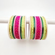 Beautifully designed bangles for any occasion. South asian bracelets come in a variety of styles, colors, and finishes. We at Banglez take creating the perfect bangle set for you to another level! You could say helping you find your favorite stack of bangles as one of our greatest missions. This bangle set was curated in house by one of our talented team members. We hope you love them as much as we do! Handmade Pink Bangle For Festive Occasions, Festive Handmade Pink Bangle, Handmade Pink Bracelets For Festive Occasions, Handmade Pink Bracelets For Festive Season, Handmade Pink Festive Bracelets, Pink Bollywood Bracelets For Festivals, Pink Bangle Jewelry For Festival, Festive Stackable Bangle Bracelets, Handmade Bohemian Pink Bangle