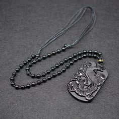 This exquisite hand-carved black obsidian pendant necklace depicts an ancient immortal Phoenix with her brood, signifying longevity, rebirth and renewal. Obsidian is said to be able cleanse negativity and encourage positive energies. Combined with the mystical Phoenix, this necklace is a meaningful gift for any loved one. Material: Natural Black Obsidian, Waxed Cord Chain, Beads Pendant Size: 6.5 x 4.2 x 1.0 cm (2.3" x 1.5" x 0.4") Necklace Length: 60 - 72cm (23.6" - 27.6") Adjustable Cord Click ADD TO CART To Order Yours Now! The Checkout Process is Guaranteed to be 100% Safe and Secure with Visa, Mastercard, AMex, Discover, Apple Pay or PayPal. Symbolic Black Jewelry For Healing, Engraved Spiritual Black Jewelry, Engraved Black Spiritual Jewelry, Black Obsidian Necklace For Healing, Black Spiritual Pendant Jewelry, Spiritual Black Pendant Jewelry, Black Symbolic Pendant Jewelry, Obsidian Amulet Necklace As Gift, Obsidian Amulet Necklace For Gift