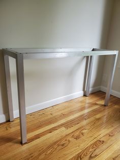 a white table sitting on top of a hard wood floor