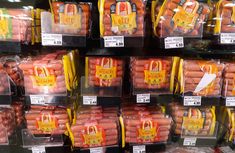 hot dogs in plastic containers on display for sale