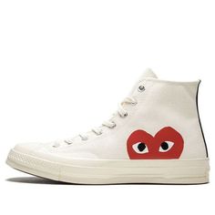 The Comme des Garçons x Chuck Taylor All Star Hi is a must-have sneaker for fashion-savvy individuals. The Off-White canvas upper and red CDG heart logo on the side panels are both stylish and eye-catching, while the vulcanized rubber midsole provides comfort and support. Released in June 2017, this sneaker is also available in a black colorway. (SNKR/Unisex/High Top/Crossover/Kawakubo Rei) Casual Sneakers With Logo-print Tongue And White Sole, White High-top Sneakers With Logo-print Tongue, Red High-top Sneakers With Logo-print Tongue, Casual High-top Sneakers With Logo-print Tongue And White Sole, Casual Mid-top Sneakers With Logo-print Tongue, Casual High-top Sneakers With Logo-print Tongue, Canvas High-top Sneakers With Logo Print, Red Casual Sneakers With Logo-print Tongue, Casual Red Sneakers With Logo-print Tongue