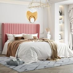 a bedroom with a pink headboard and white bedding, beige throw rugs