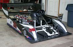 a race car is parked in a garage