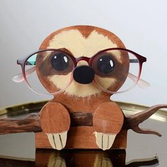 a stuffed slotty wearing glasses sitting on top of a table