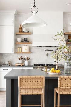 a kitchen with two chairs and an island