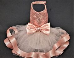 a tutu skirt with a bag on top and a bow tie around the waist