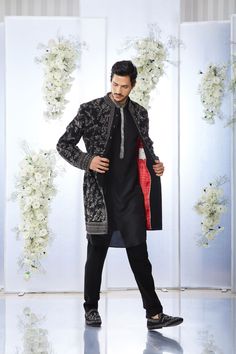 This black short sherwani set features tonal all over zardosi embroidery on a japanese base. It is paired with a black silk kurta and a japanese trouser. Complimenting stole and footwear is also available. From Seema Gujral's Tuscan Summer collection. DELIVERY TIMEPlease allow 4 months for your outfit to arrive.FABRIC DETAILSJapaneseProfessional cleaning only. Traditional Black Bandhgala With Resham Embroidery, Elegant Black Raw Silk Traditional Wear, Black Raw Silk Traditional Wear For Designer Occasions, Designer Black Bandhgala With Intricate Embroidery, Designer Black Raw Silk Traditional Wear, Black Embroidered Bandhgala With Traditional Drape, Elegant Black Kurta With Intricate Embroidery, Elegant Embroidered Jamawar Bandhgala, Embroidered Black Bandhgala With Traditional Drape