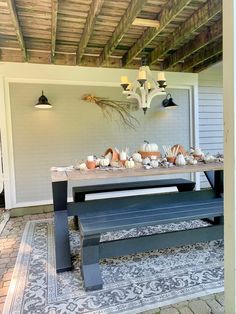 an outdoor dining area with a table and bench