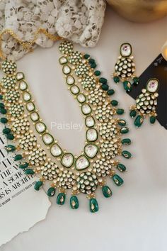 The majestically handcrafted green Polki necklace set is an ode to the Indian tradition and intricate work handcrafted by the artisans of India. The green meenakari work with shell pearls is a masterpiece inspired by Sabyasachi jewelry to give you a royal look. The bold and bright design of the necklace is perfect for all the beautiful brides to be!  Pair this replica of an ancestral jewelry necklace set with your ethnic or contemporary ensembles and create a look to remember.  Necklace Closure Traditional Kundan Necklace With Emerald, Traditional Emerald Kundan Necklace Hand Set, Traditional Emerald Kundan Necklace, Green Temple Jewelry For Gifts, Green Temple Jewelry As Gift, Green Emerald Jewelry For Festivals, Green Hand Set Kundan Necklace In Temple Style, Green Kundan Jewelry With Meenakari, Traditional Kundan Necklace With Meenakari And Emerald