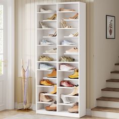 a white shoe rack filled with lots of shoes