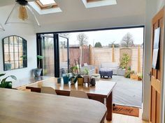 an open kitchen and living room with sliding glass doors