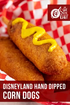 a close up of two hot dogs in a basket with ketchup and mustard