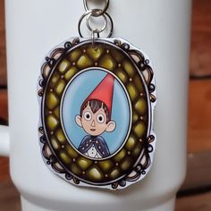 a close up of a key chain with a cartoon character on it's face